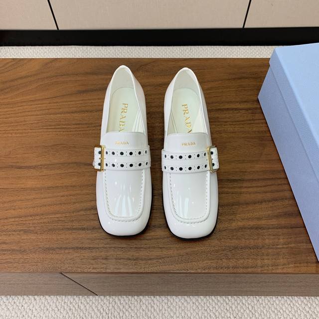 Pra*A Single-Strap Shoe. A Small Square Toe Paired With A Small Heel Creates A R