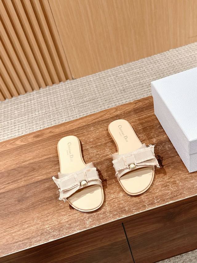 Dior's new pearl butterfly slippers. The black tasseled grosgrain upper is full