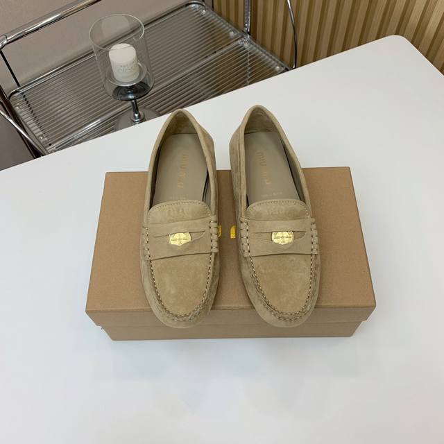 Mium*U coin loafers. Cow suede decorated with coins and embossed Miu logo, showi