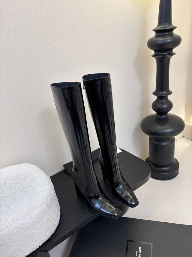 Yves Saint Laurent high boots The pointed toe and stiletto heel complement each