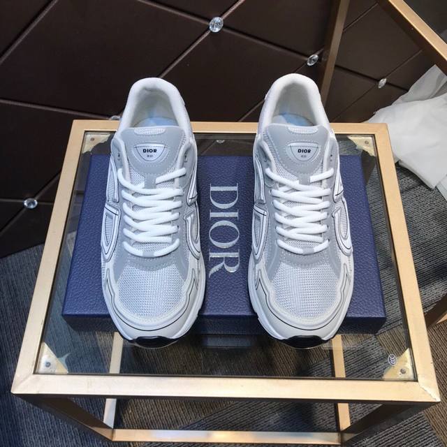 D's new low-top sneakers are crafted from gray mesh and white technical fabrics,