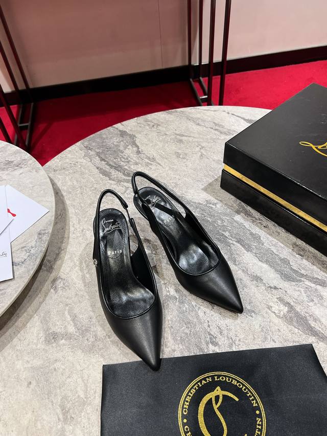 Cl-strap Slingback W. These pumps are crafted from black calfskin leather and fe