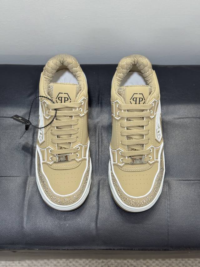 Hilipp Plein, a trendy German men's low-top sneaker, features a rhinestone-finis