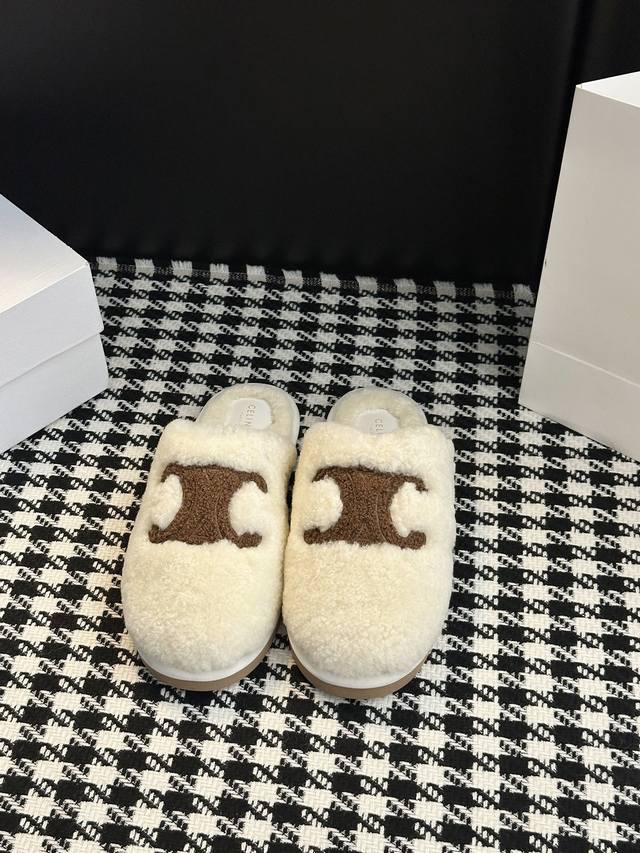 fur slippers are a fashionable winter warmer. The iconic Arc de Triomphe logo em