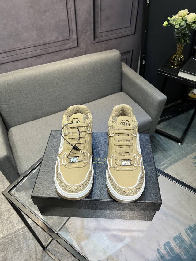 Hilipp Plein, a trendy German men's low-top sneaker, features a rhinestone-finis