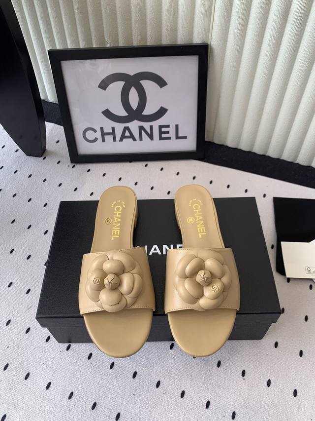 Chanel's new Camellia Roman slippers. The delicate, three-dimensional camellia f