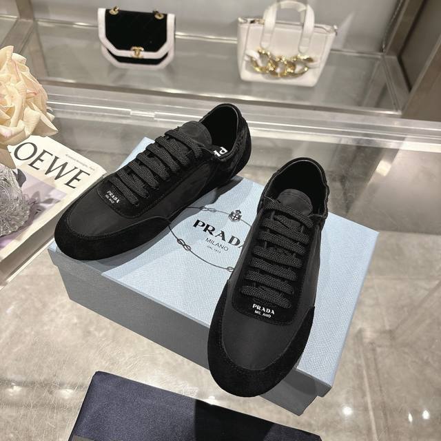 the latest Prada model. This ultra-lightweight sneaker is crafted from recycled
