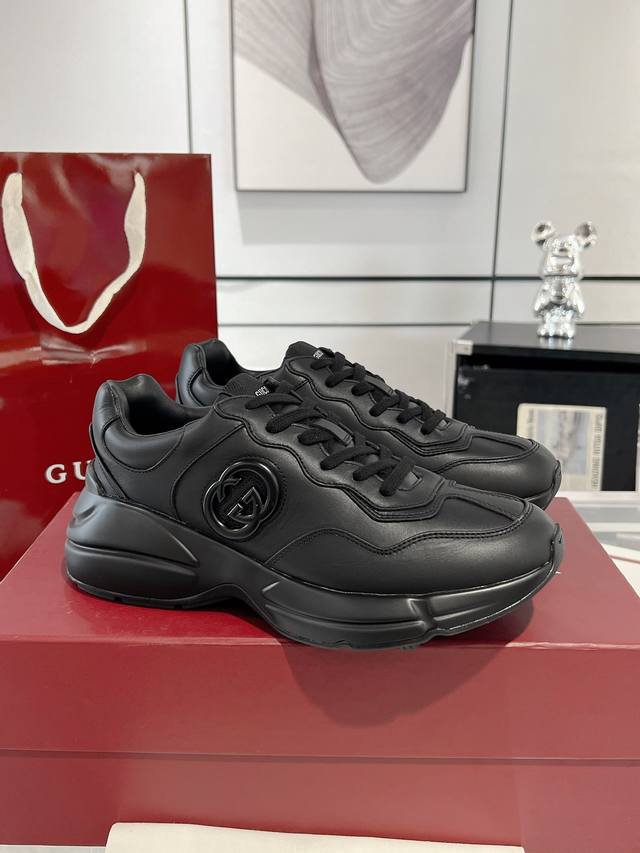 Gucci's new Rhyton series, a couple's sneaker, introduces a new black leather mo