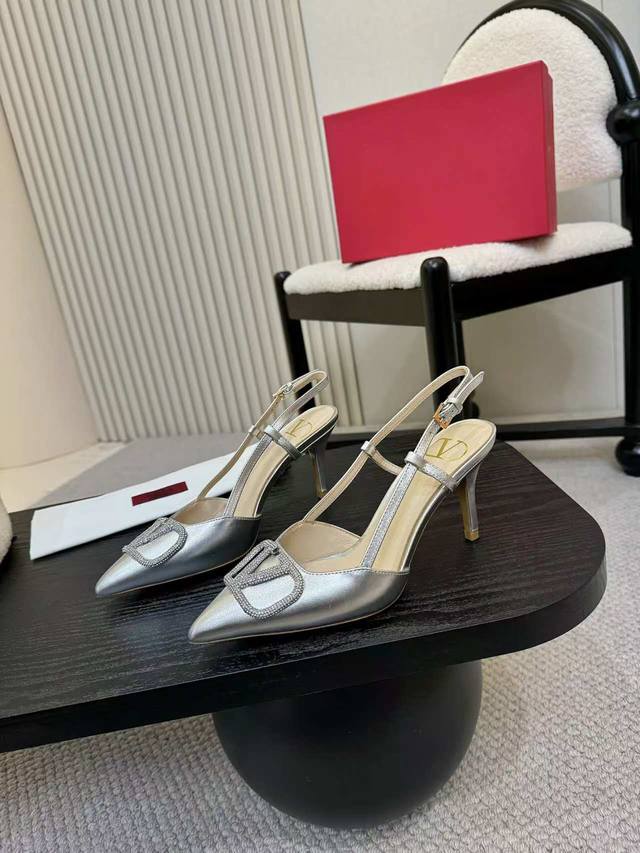 Kloss diamond-buckled Valentino sandals with large V-neck buckle. Authentic vers