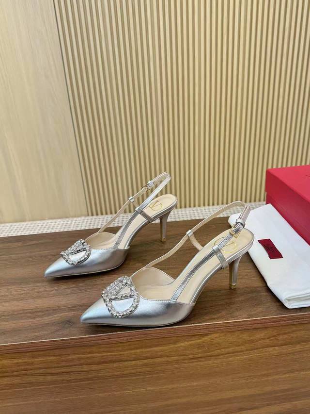 Kloss diamond-buckled Valentino sandals with large V-neck buckle. Authentic vers
