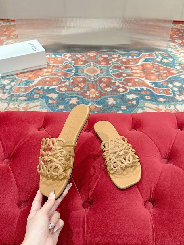 Loewe's 2025 summer hit, soft cowhide Petal Anagram hollowed-out sandals. Beside