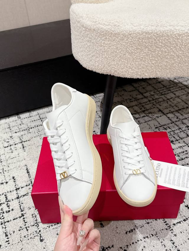 Premium couple's pair of Valentino 25 Royco series casual sneakers. Originally p