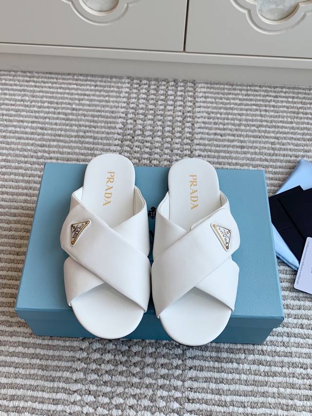 Prada's new triangle logo flat cross-strap sandals are top-quality. These sandal