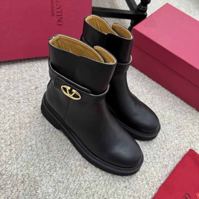 Valentino ankle boots. These V-neck boots feature metallic accents and rivets fr