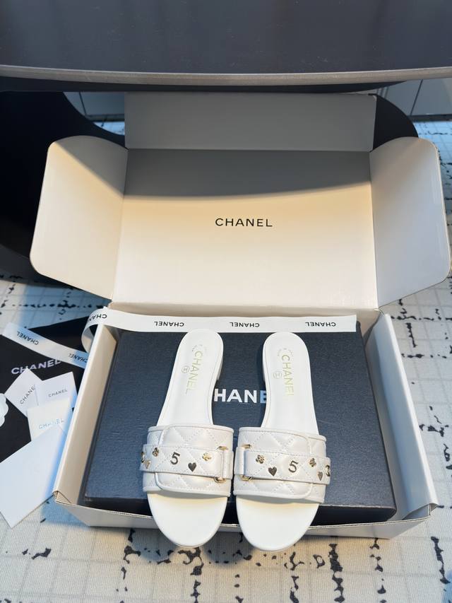 Chane* The Chanel 25C metal lettered sandals feature the iconic diamond pattern