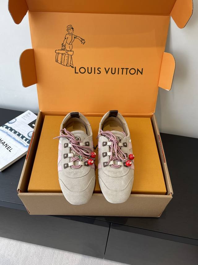 a top-tier version for women and men, featuring cherry accessories. Louis Vuitto