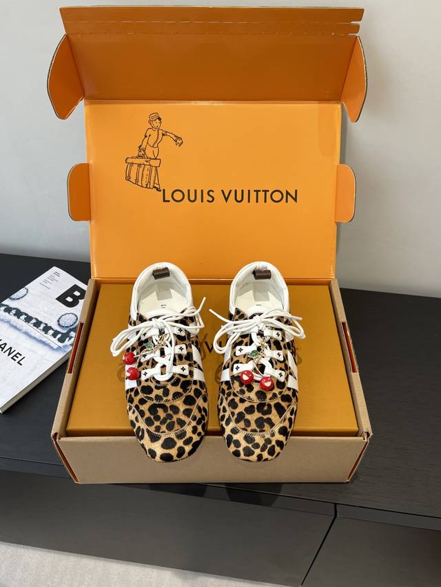 a premium version for women and men, featuring cherry accessories. Louis Vuitton