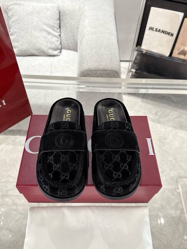 Guccl Women's Double G Half-Slip Mule. This versatile design combines the brand'