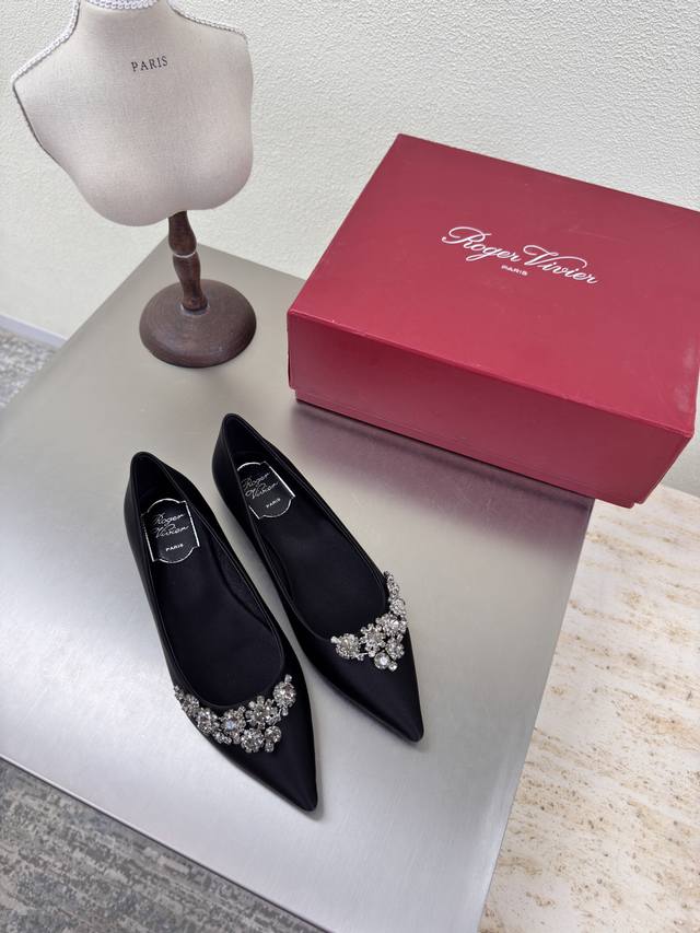 flat-soled, pointed-toe shoes with a floral diamond buckle. Classic, Roger Vivie