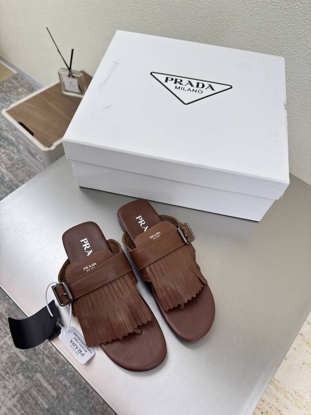 Vintage tasseled Prada flip-flops. Flat-soled design with a simple triangle logo