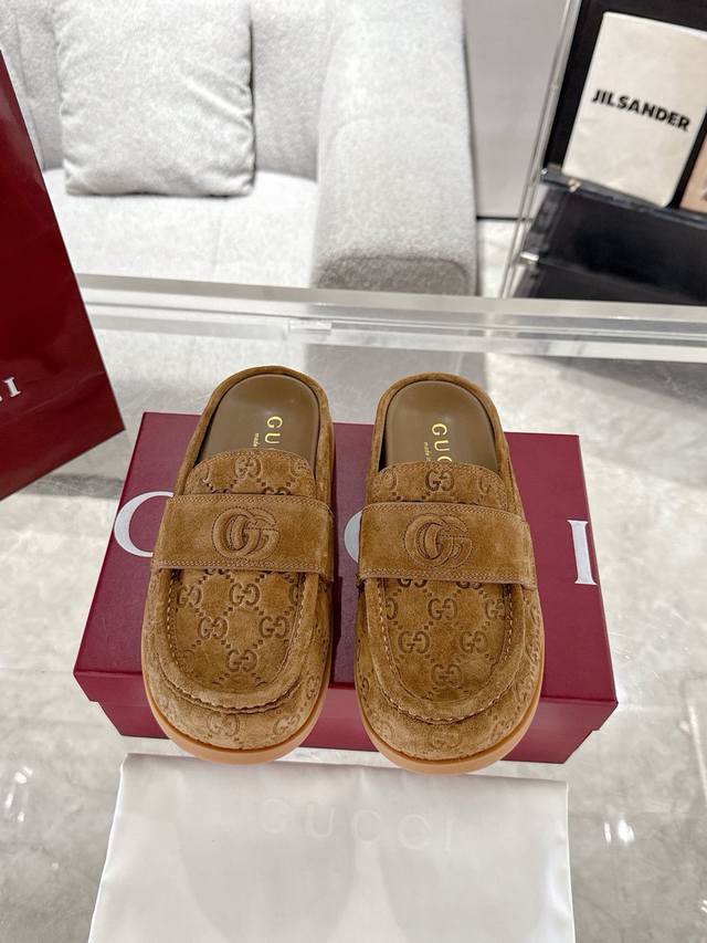 Gucci Women's Double G Half-Slip Mule. This versatile design combines the brand