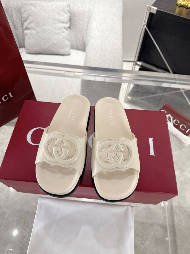 Couple's Gucci Buckle Double G Slides. Crafted from iconic Gg canvas, these sne