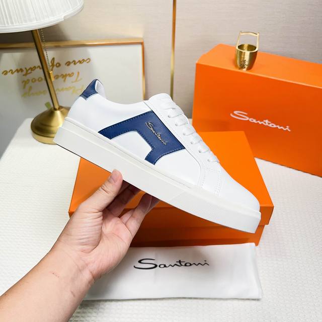 Santoni These low-top men's sneakers are crafted from white and orange leather,