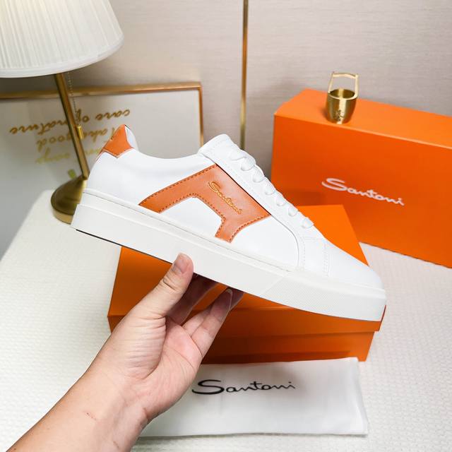 Santoni These low-top men's sneakers are crafted from white and orange leather,