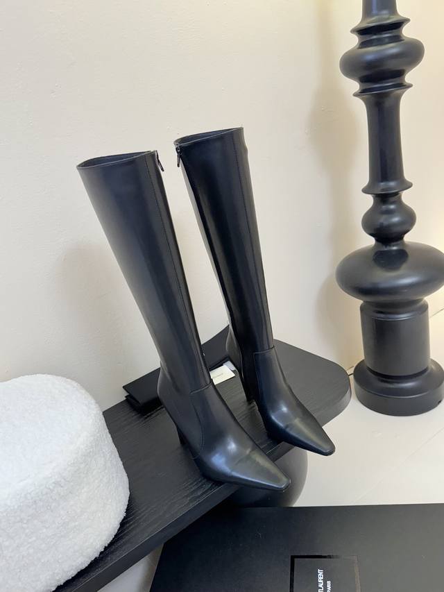 Yves Saint Laurent long boots DDD. The pointed toe and stiletto heel complement
