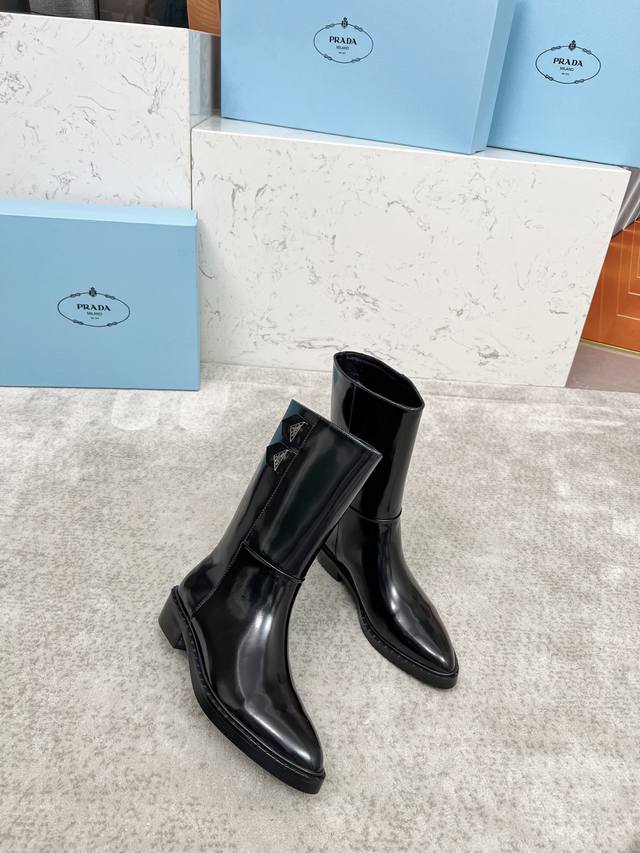 A luxurious version of the classic Prada triangle-shaped pointed-toe boots, per
