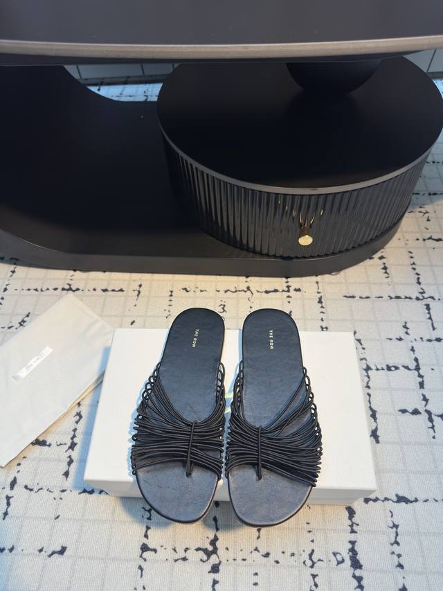 The Row 25Ss woven rope flat slippers DDD. The sleek ropes crisscross like artis