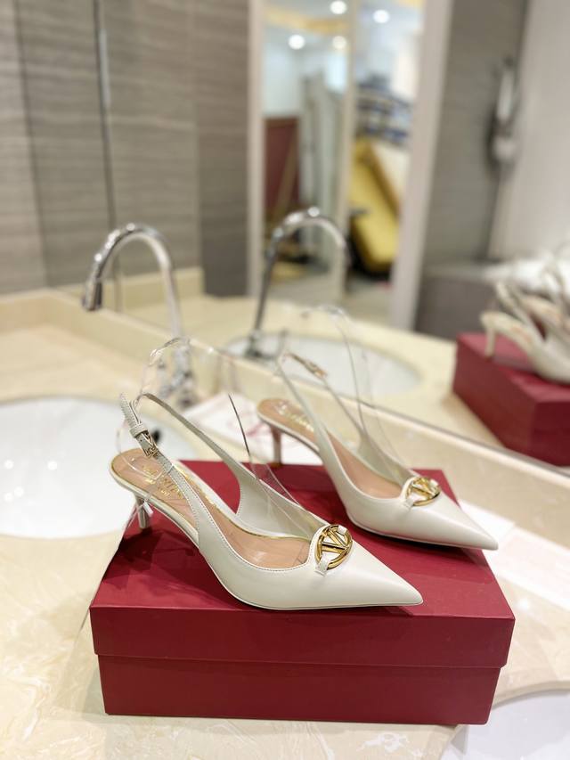 Valentino's newest logo, the logo Signature, features a light gold accent buckle