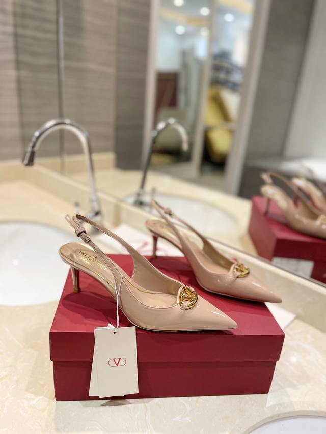 Valentino's newest logo, the logo Signature, features a light gold accent buckle