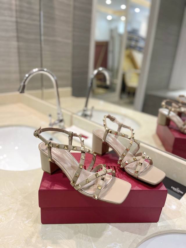 Valentino's newest sandals with classic rivets pair well with simple or fashiona
