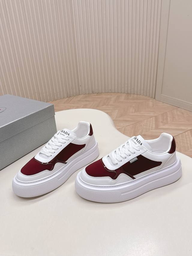 A couple's pair of Prada white sneakers, a classic update to the casual sneaker