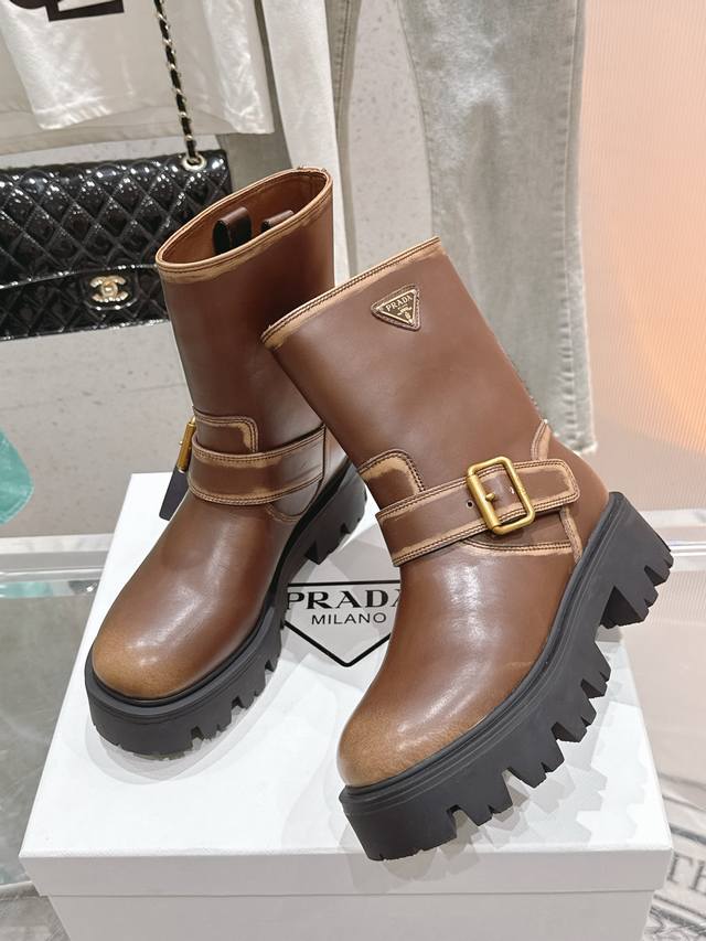 Prada's latest F041 series, a mid-calf Martin boot with a triangular buckle and