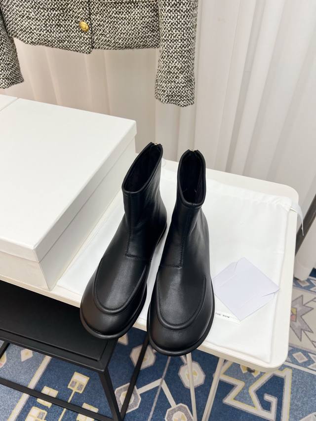 The Row's classic retro round-toe flat ankle boots evoke a sense of quiet sophis