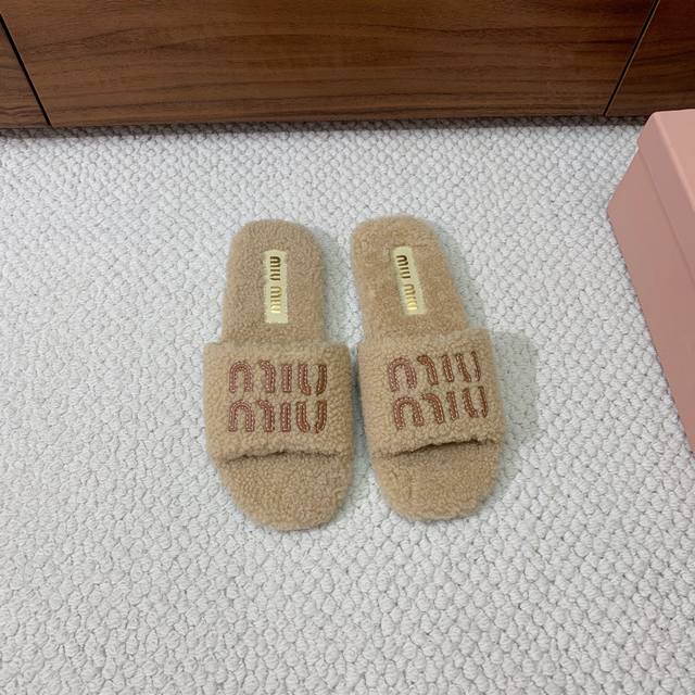 Mium*U's iconic flat fur slippers. Seen on the covers of every major fashion mag