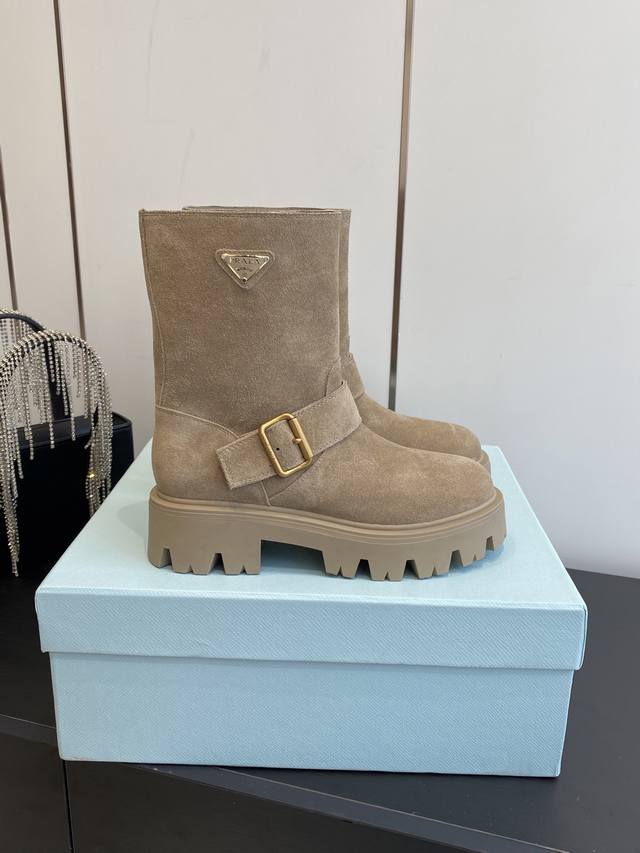 Prada's classic triangle-shaped slip-on boots (DDD) are a must-have for women. A