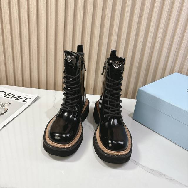 Prada's classic triangle-shaped women's boots are a must-have this winter! They'