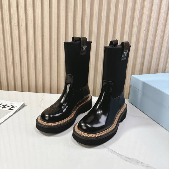 Prada's classic triangle-shaped slip-on boots are a must-have for women this win