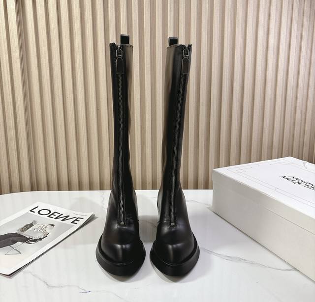 McQueen's new 25Ss minimalist leather high boots. These minimalist, ultra-soft,
