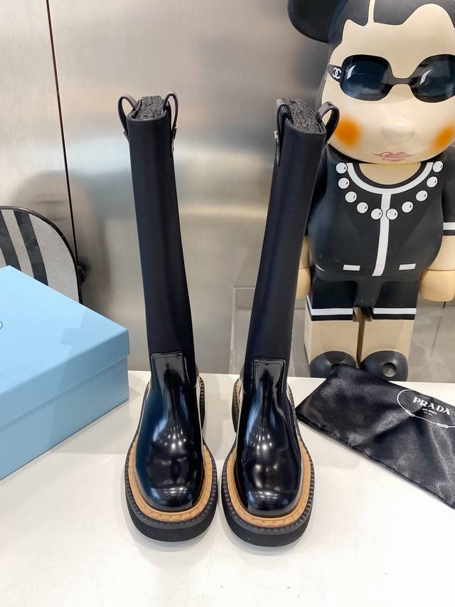 Factory-made Prada classic triangle-label slip-on boots for women. This winter'