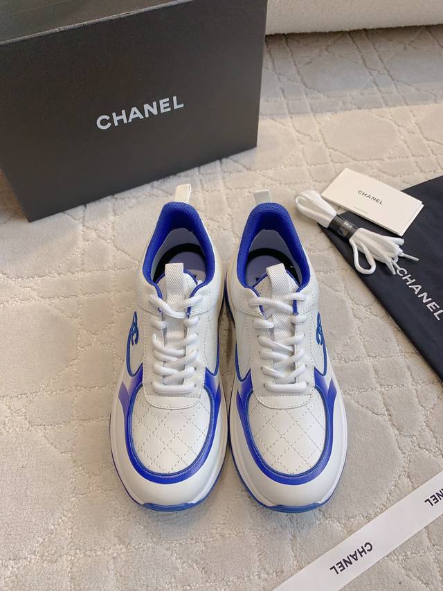 Chane*'s new thick-soled sneakers in the classic black and white panda colorway