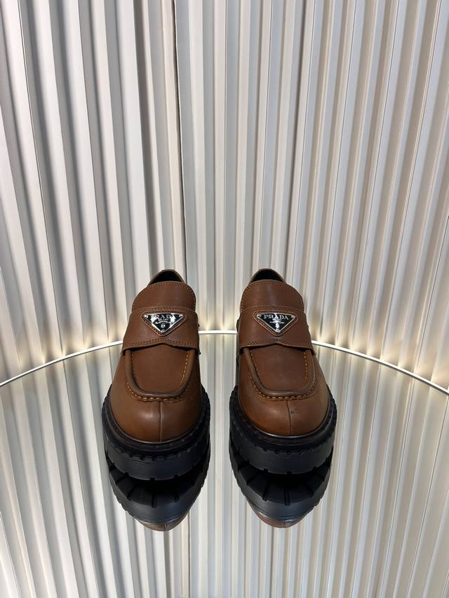 Top-of-the-line Prada loafers with new triangle buckle and thick sole are super