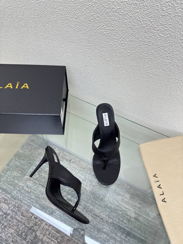 Alaia high-heeled flip-flops from Paris Black cowhide with patent leather embell