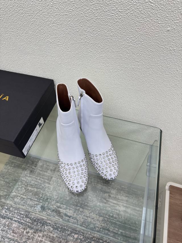 Diamond spike short boots with mid-heel and round toe Alaia boots are from Paris