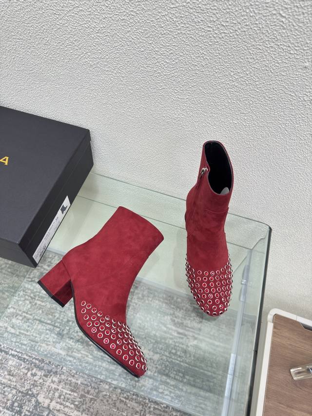 Diamond spike short boots with mid heel and round toe Alaia boots are from Paris