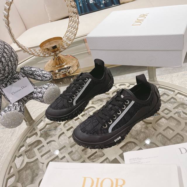 Dior monogrammed lace-up sneakers with low-tops and high heels. These sneakers a