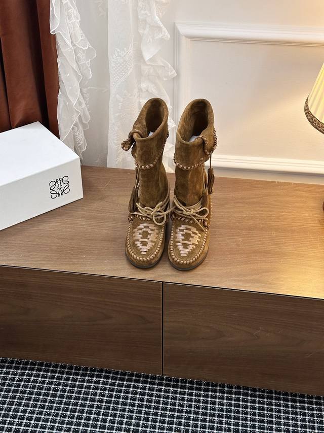 Lace-up Ankle Boots . Hand-woven laces wrap around the ankle, resembling the k